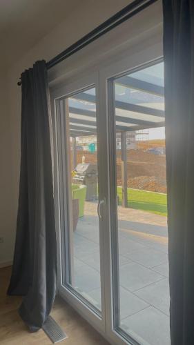 a sliding glass door with a view of a yard at Moderne Ferienwohnung Bad Rappenau in Bad Rappenau