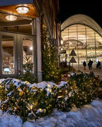 a christmas tree in front of a building with snow at City center Panorama in Tromsø