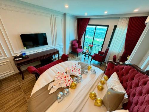 a living room with a table and a couch at Luxury Hanoi Hotel in Hanoi