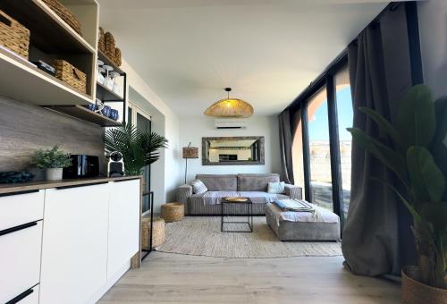 un salon avec un canapé et une table dans l'établissement La Terrasse de Marie - superbe vue, terrasse, piscine, à Cavalaire-sur-Mer