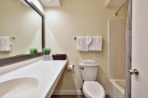 a white bathroom with a sink and a toilet at Hotel Style Condo Promising a Comfortable and Convenient Retreat right in the heart of Vermont ski country in Killington
