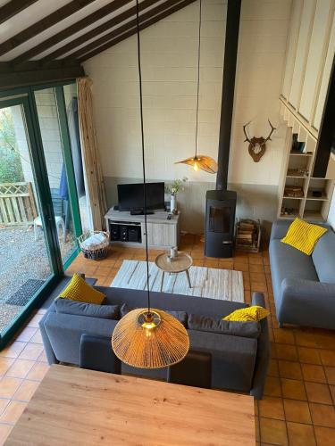 a living room with a couch and a table at Mon CoCoo in Stavelot