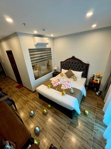 a bedroom with a bed with balls on the floor at Luxury Hanoi Hotel in Hanoi