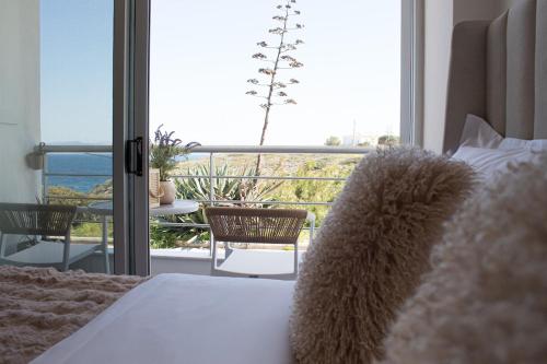 a bedroom with a bed and a view of a balcony at RAFINAS PARADISE VIEW!! Walking access to the Port!! Amazing Seaview!!! in Rafina