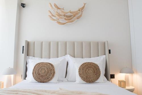 a bedroom with a white bed with white pillows at RAFINAS PARADISE VIEW!! Walking access to the Port!! Amazing Seaview!!! in Rafina