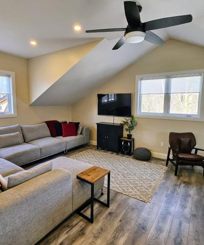a living room with a couch and a ceiling fan at Redwood Suite in Niagara on the Lake