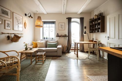 a living room with a couch and a table at KRABBES Hafenliebe in Neustadt in Holstein