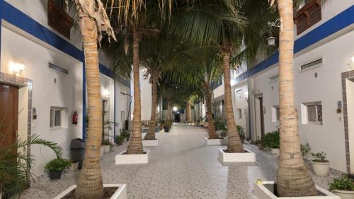 a corridor with palm trees in a building at فلل الخالدية in Jeddah