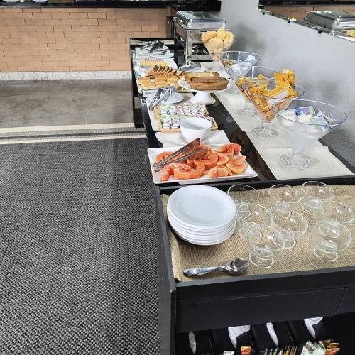 uma linha de buffet com pratos de comida e bebidas em Pousada e Restaurante Vila Dona Gloria no Guarujá