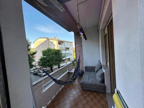 a hammock in a balcony of a building at Rocci di Fontana by K-rol in Alba