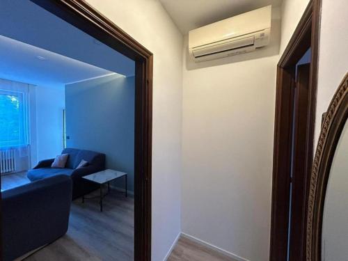 a living room with a blue couch and a air conditioner at Rocci di Fontana by K-rol in Alba