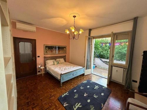 a bedroom with a bed and a large window at Rocci di Fontana by K-rol in Alba