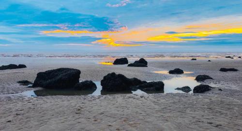 a group of rocks on a sandy beach at Brean & Berrow Rooms in Berrow