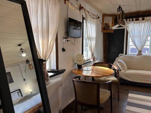 a small room with a table and a bed at Hnameni Bovadzor Lodge in Maksim Gorʼkiy