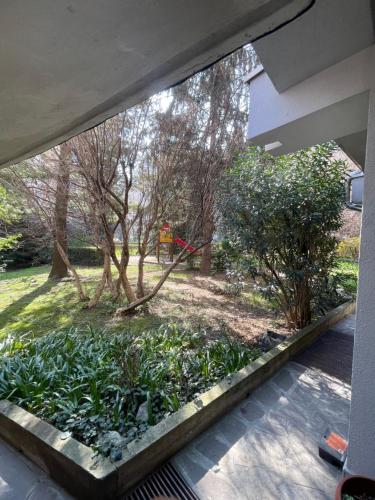 a garden view from the inside of a house at MMBook Casa Zucca Rho Fiera Milano in Rho