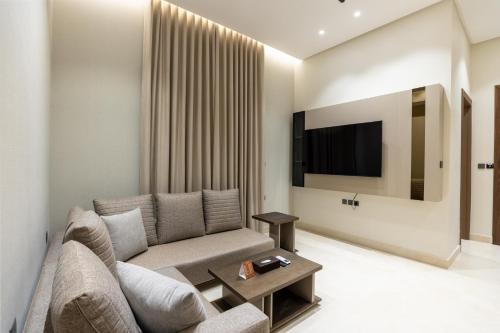 a living room with a couch and a tv at Liora ليورا in Riyadh