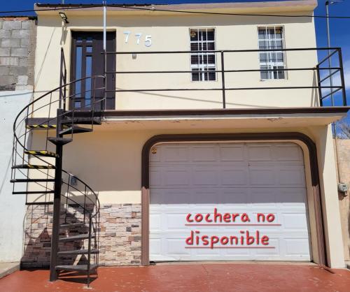 a garage door with a no descriptive sign on it at GR20acd Doris in Cuauhtémoc