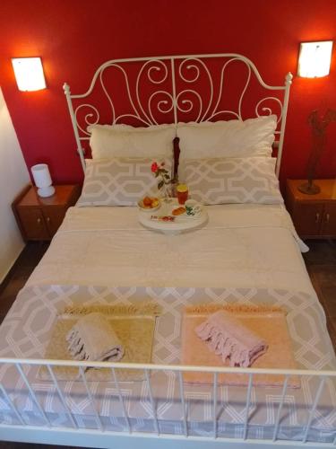a white bed with a tray of food on it at Lagoon Beach House in Nea Potidaea
