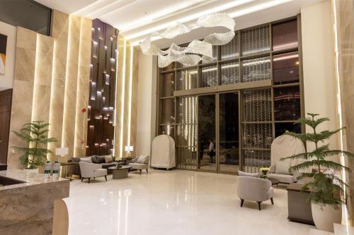 a lobby with couches and chairs and a chandelier at Liora ليورا in Riyadh
