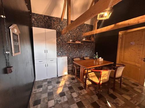a dining room with a table and chairs at Hnameni Bovadzor Lodge in Maksim Gorʼkiy