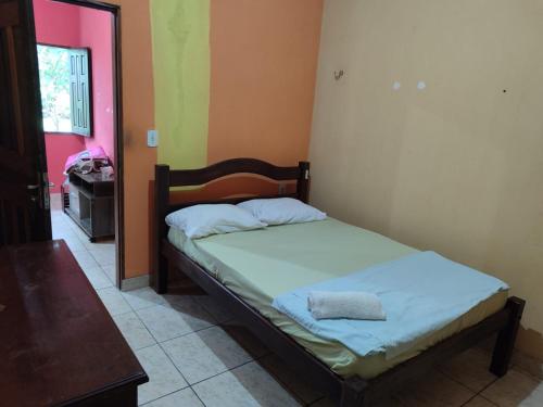 a bedroom with a bed in a room with a door at Quartos em Alter do Chão in Santarém