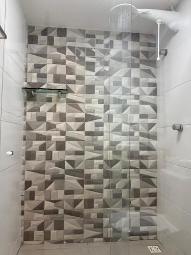 a shower with a glass door in a bathroom at Pousada Alma Noronha in Fernando de Noronha