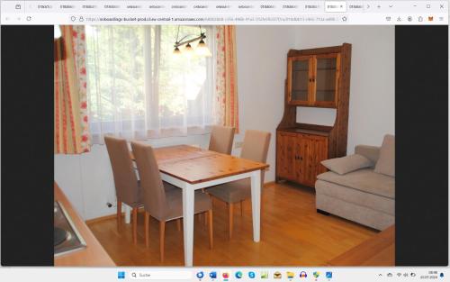 a dining room table and chairs in a room at Naturhaus Andrea in Grossarl