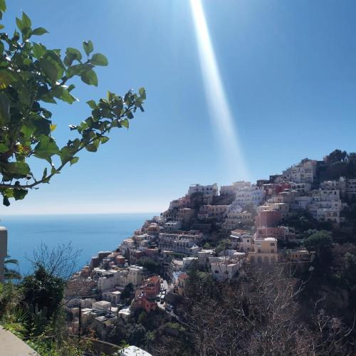 a city on a hill with the ocean in the background at Positano Casa Delizia in Positano