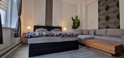 ein Wohnzimmer mit einem Bett und einer Couch in der Unterkunft Top3 Ferienwohnung mit Fitnessstudio in Plauen