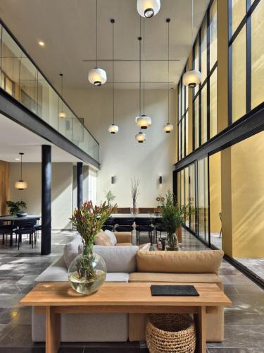 a living room with a couch and a table at Apartment A/C, GYM, Cafeteria | Telmex Auditorium in Guadalajara