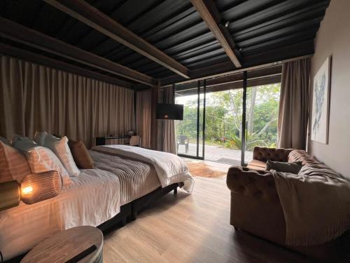 a bedroom with a large bed and a couch at 1 Relax, luxury room, everything you need in Salento