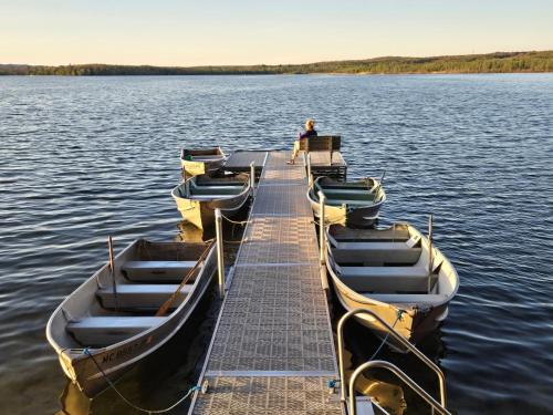 a group of boats tied to a dock on a lake at Lake Access! Twin Birch Resort - Kodiak Cabin in Honor