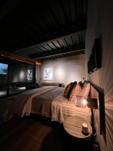 a bedroom with a bed and a table with a lamp at 1 Relax, luxury room, everything you need in Salento