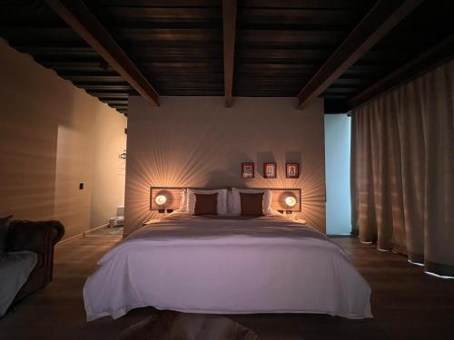 a bedroom with a large bed with two lights on it at 1 Relax, luxury room, everything you need in Salento