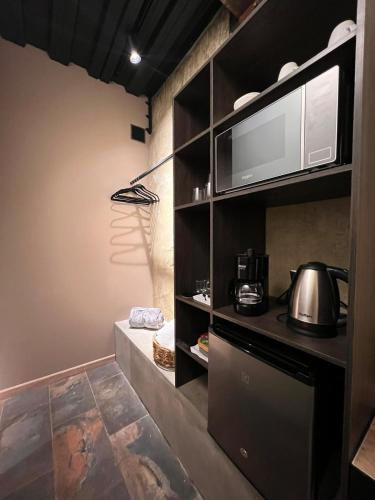 a kitchen with a stove and a microwave at 1 Relax, luxury room, everything you need in Salento