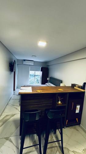 a room with a desk with two chairs and a keyboard at 2 de abril apartamento in San Miguel de Tucumán