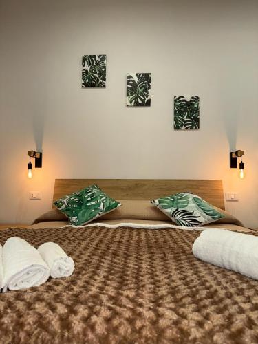two beds with pillows on them in a bedroom at Le Palme - Holiday Home in Brindisi