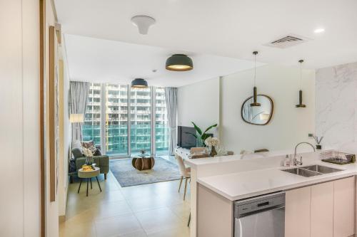 a kitchen and living room with a view of a building at Sea View Apartment located on the 39th floor with rooftop pool close to world trade centre in Dubai