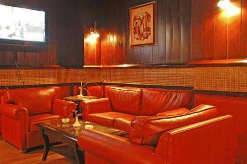 a restaurant with red leather seats and a table at فندق أميري سويت in Umm Uthainah
