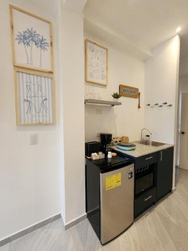 a kitchen with a stove and a counter top at Loft in the heart of El Sunzal in Tamanique
