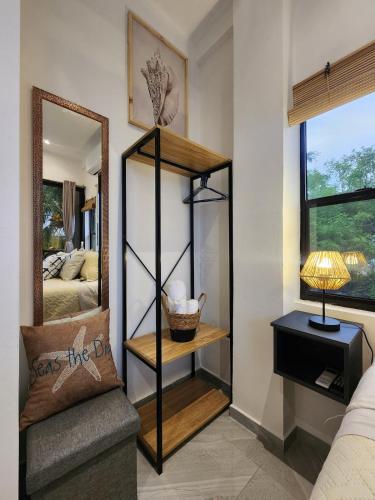 a room with a mirror next to a bed at Loft in the heart of El Sunzal in Tamanique