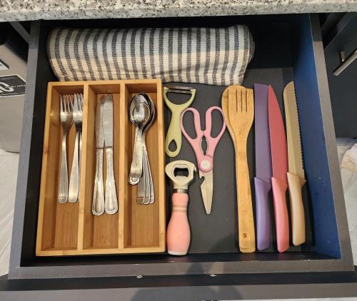 a drawer with utensils in a box at Loft in the heart of El Sunzal in Tamanique