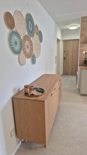 a kitchen with a wooden counter with plates on the wall at Apartmán pri mlyne in Nové Zámky