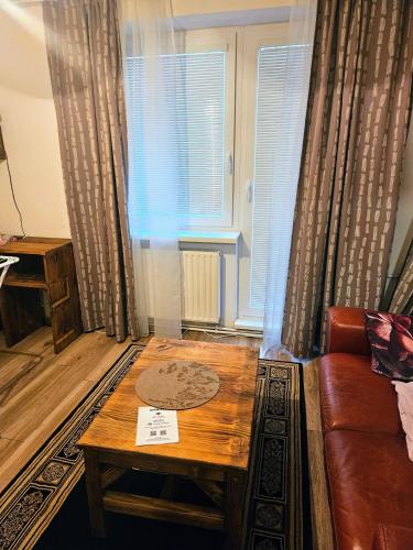 a living room with a couch and a table at MK Apartment Hron in Podbrezová