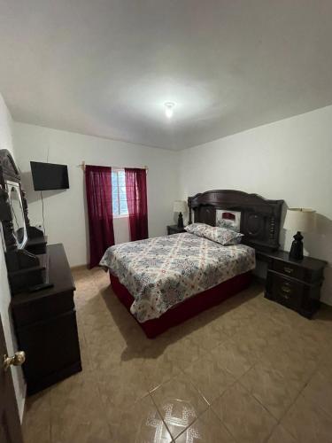 a bedroom with a bed and a television in it at GR20acd Corredor Comercial in Cuauhtémoc