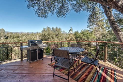 una terraza con mesa, sillas y parrilla en Spacious Mountain View Oasis - Pool, Spa & Game Rm, en Oakhurst