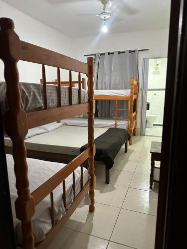 a bedroom with two bunk beds in a room at Beach House Cabo Frio Hostel in Cabo Frio
