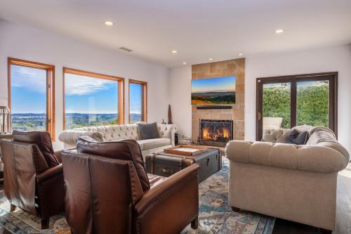 a living room filled with furniture and a fireplace at Luxury Home Atop the Hills in Santa Barbara