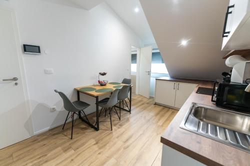 a kitchen with a table and chairs in a room at GOLDEN OASIS Free Private Parking in Ljubljana
