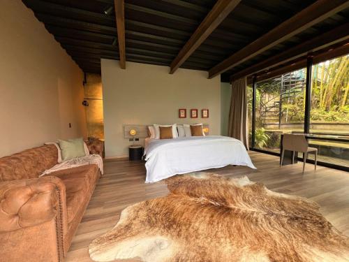 a bedroom with a bed and a couch at 1 Relax, luxury room, everything you need in Salento